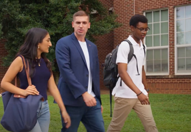 Adult walking and talking to students